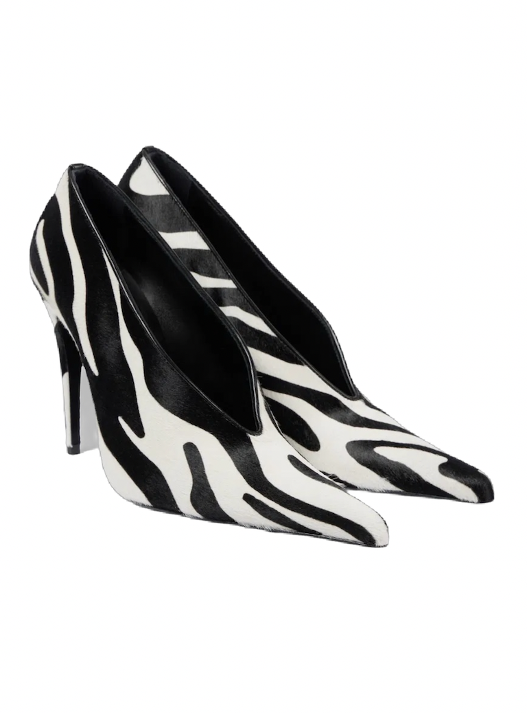 Pair of black-and-white zebra-print pointed-toe high heels with slim stiletto heels, displayed together on a white background; bold, stylish look.