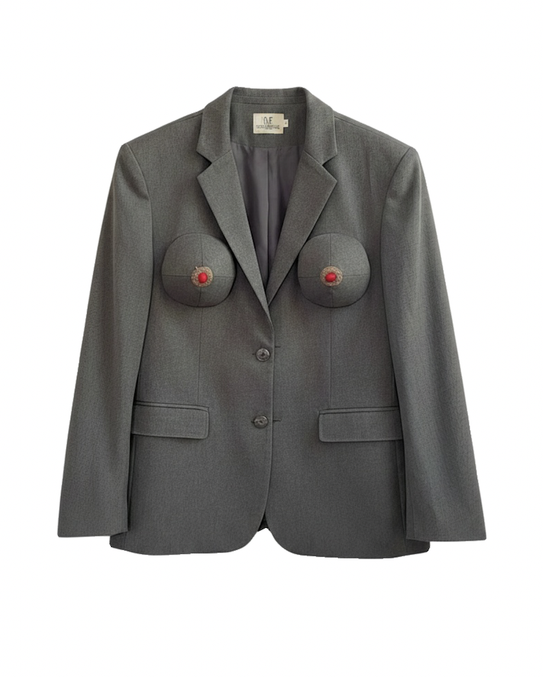 Gray tailored blazer with notched lapels, flap pockets, and two rounded chest embellishments with red centers, isolated on white.